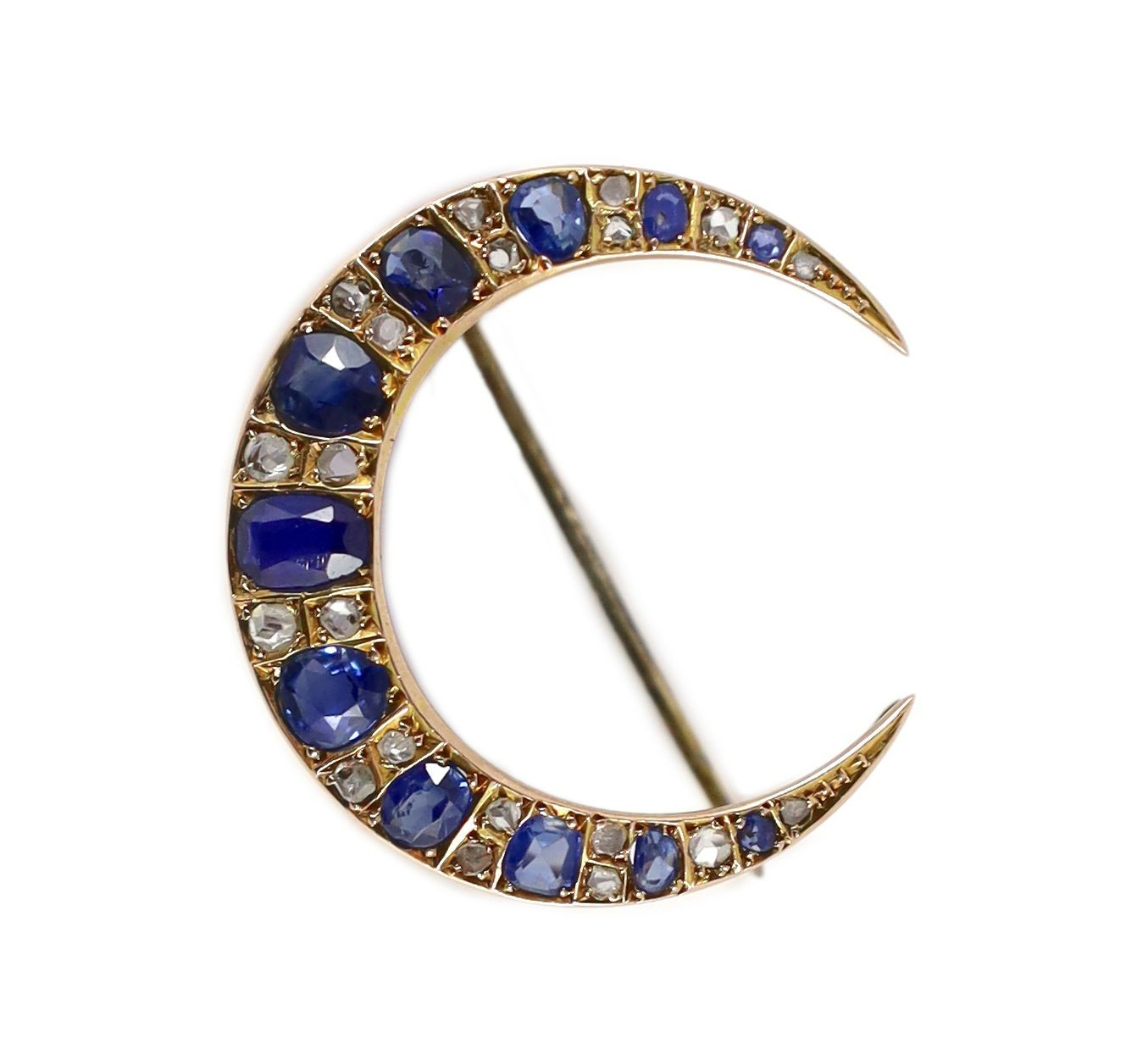An Edwardian gold and graduated oval cut sapphire and rose cut diamond set crescent brooch